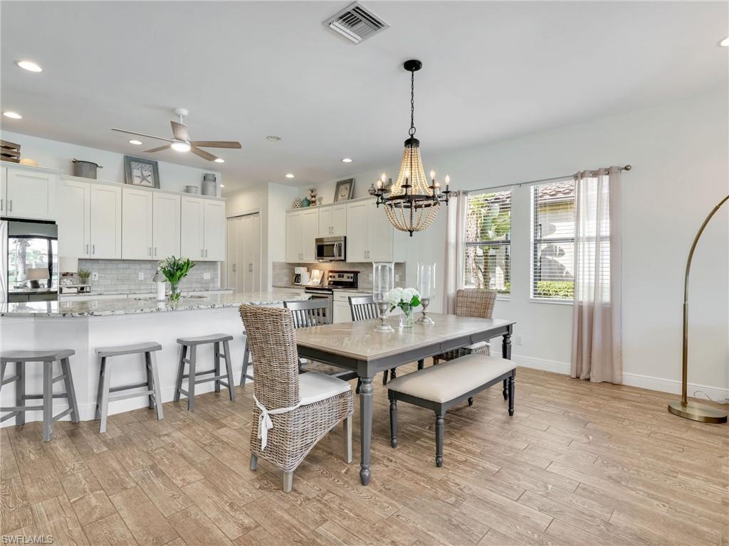 4743 Abaca Circle Naples, FL 34119 - Photo 19 of 50 Dining space featuring a chandelier, light wood-style floors, recessed lighting, and a ceiling fan