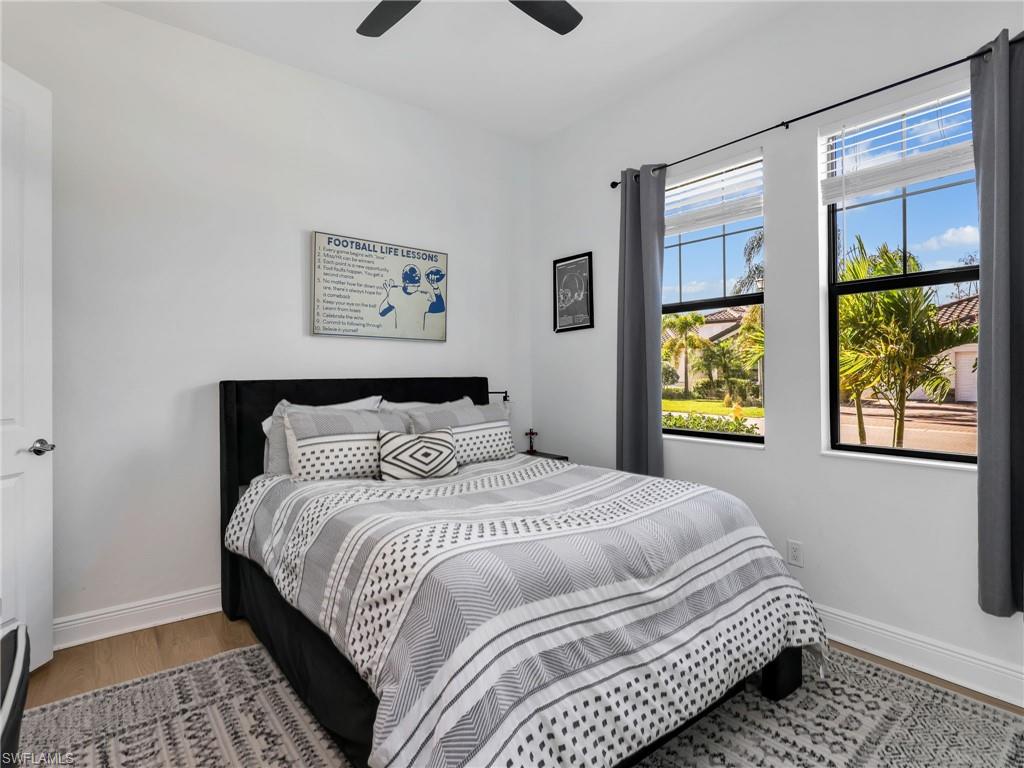 4743 Abaca Circle Naples, FL 34119 - Photo 31 of 50 Bedroom featuring light wood-style flooring and a ceiling fan