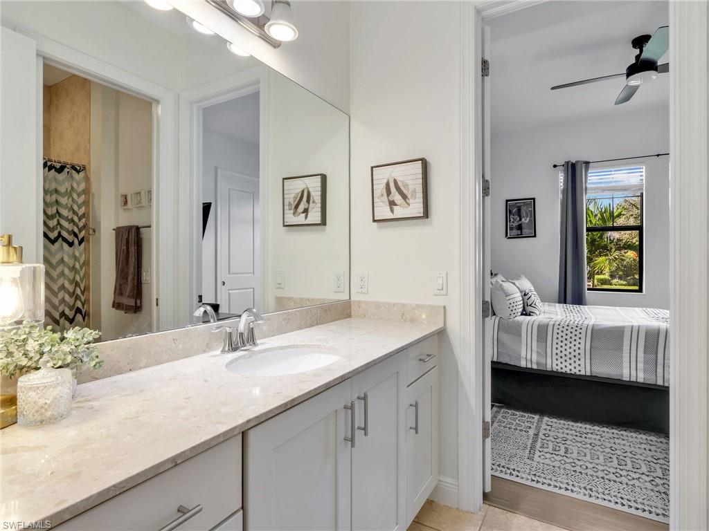 4743 Abaca Circle Naples, FL 34119 - Photo 33 of 50 Full bath featuring ensuite bath, vanity, ceiling fan, and a shower with shower curtain