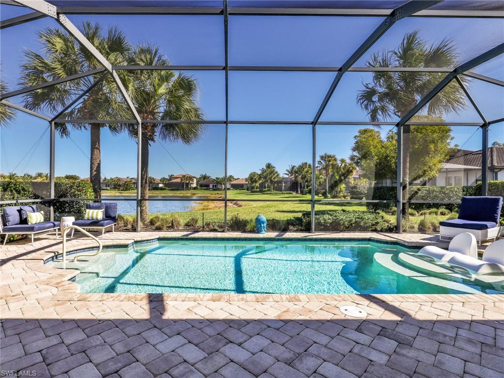 4743 Abaca Circle Naples, FL 34119 - Photo 38 of 50 Swimming pool featuring glass enclosure, a sunroom, and a patio area