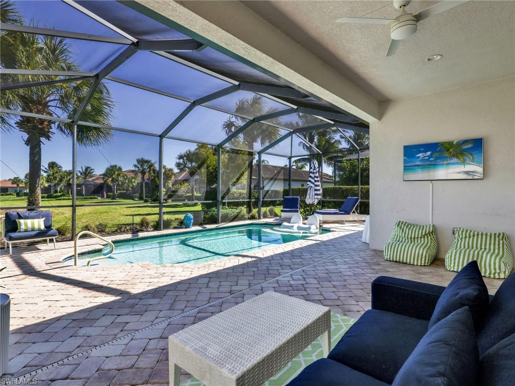 4743 Abaca Circle Naples, FL 34119 - Photo 43 of 50 Swimming pool with a patio, a sunroom, a lanai, and a lawn