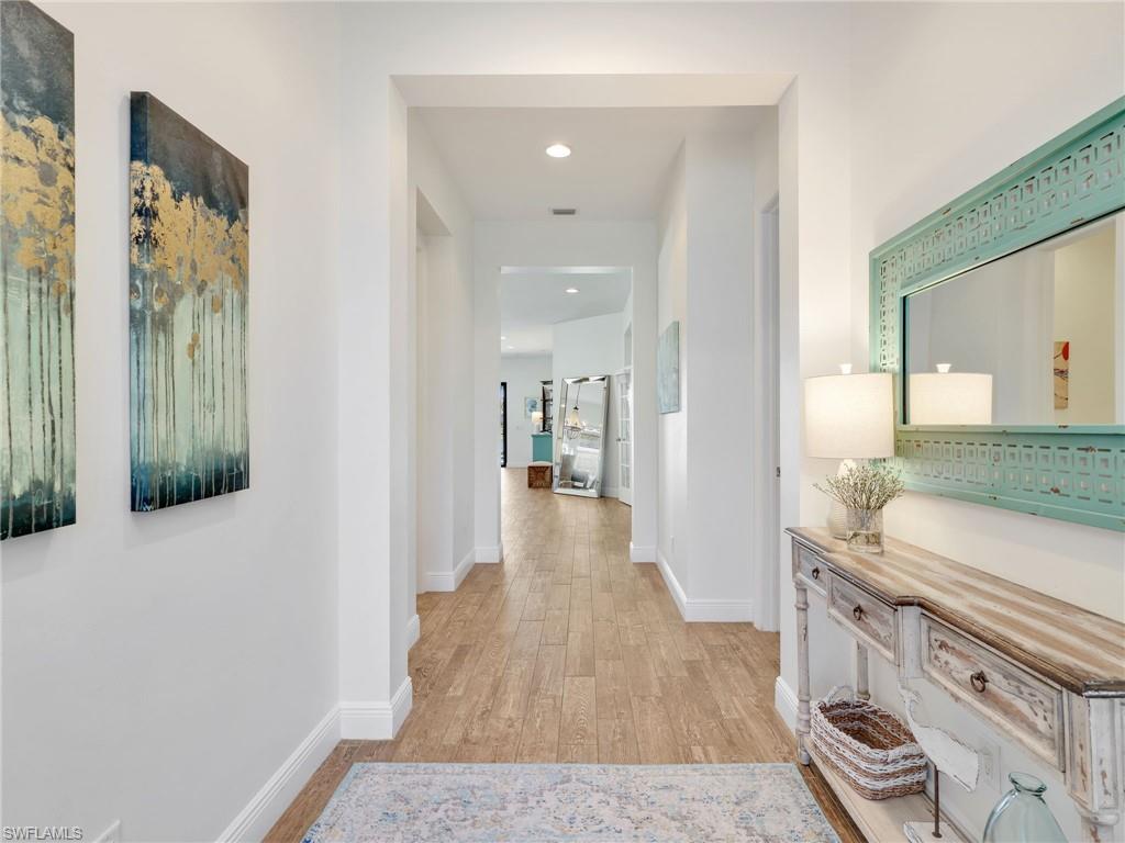 4743 Abaca Circle Naples, FL 34119 - Photo 9 of 50 Hallway with light wood-style floors and recessed lighting