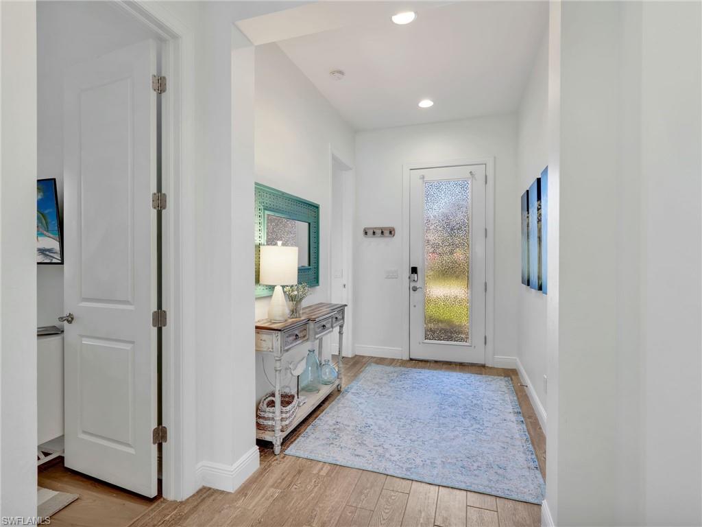 4743 Abaca Circle Naples, FL 34119 - Photo 10 of 50 Entryway with light wood finished floors and recessed lighting