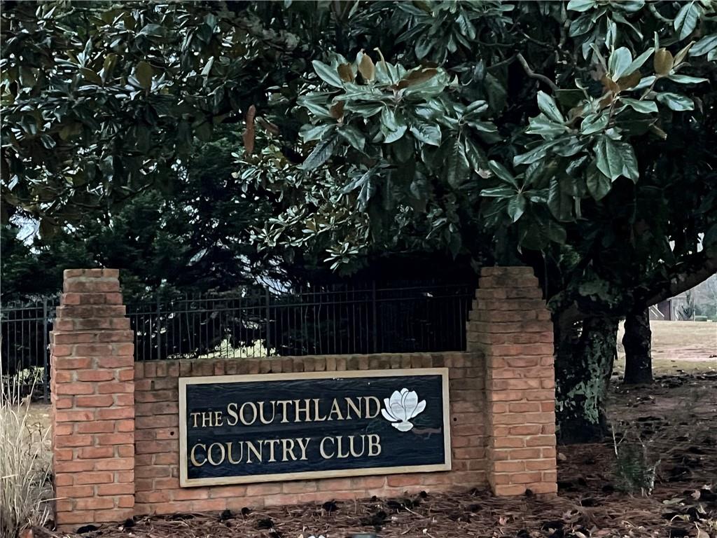 1075 Falkirk Lane Stone Mountain, GA 30087 - Photo 2 of 6 a sign that is sitting on a brick wall