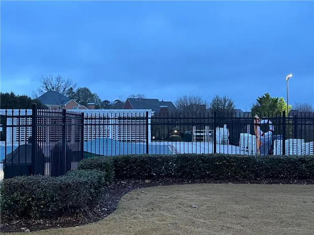 a view of a chair and table and wooden fence
