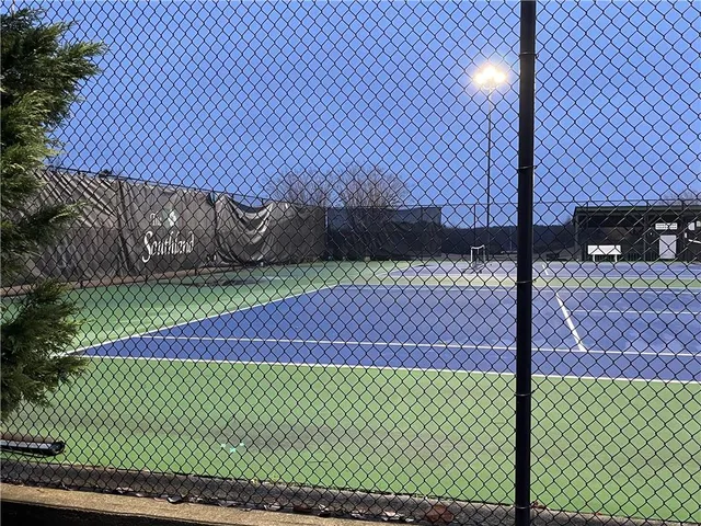 a view of a yard with wooden fence