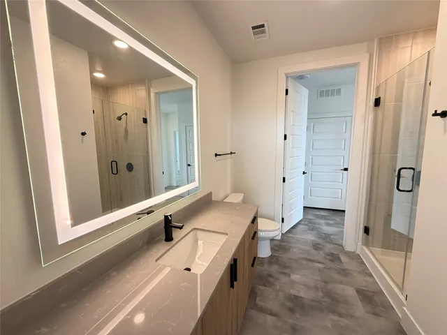 a bathroom with a tub a sink and a large mirror