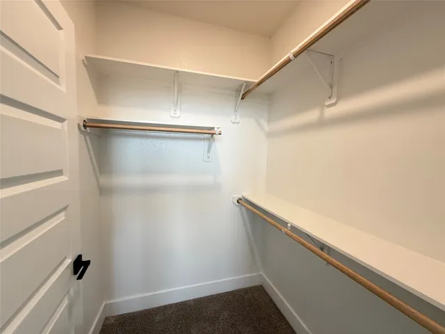 a view of closet with wooden floor