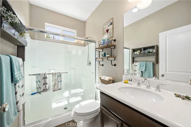 a kitchen with a table chairs refrigerator and cabinets