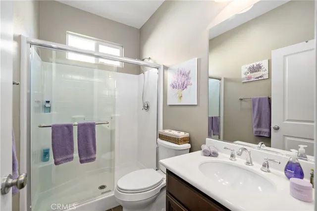 a view of a hallway with wooden floor and entryway