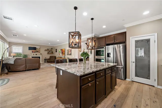 a view of a city with lawn chairs under an umbrella