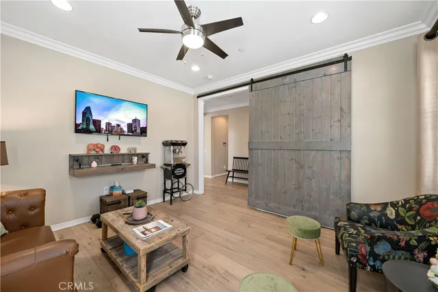 a kitchen with stainless steel appliances granite countertop a refrigerator a stove top oven a sink dishwasher and white cabinets with wooden floor