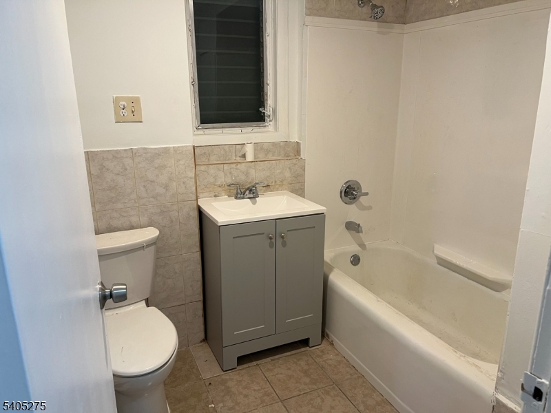 12 Quincy Street, Unit 1 Passaic, NJ 07055 - Photo 11 of 16 a bathroom with a sink toilet and tub