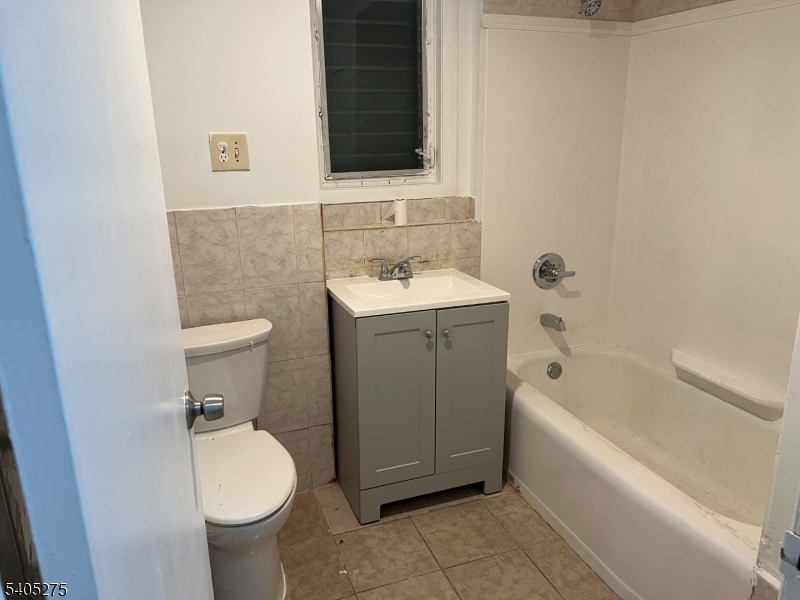 12 Quincy Street, Unit 1 Passaic, NJ 07055 - Photo 12 of 16 a bathroom with a sink toilet and bathtub