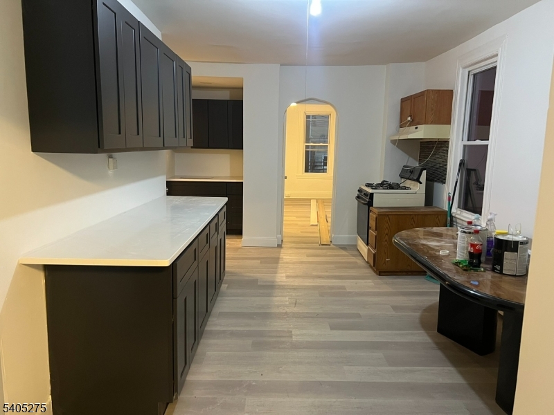 12 Quincy Street, Unit 1 Passaic, NJ 07055 - Photo 7 of 16 a kitchen with stainless steel appliances granite countertop a sink stove and cabinets