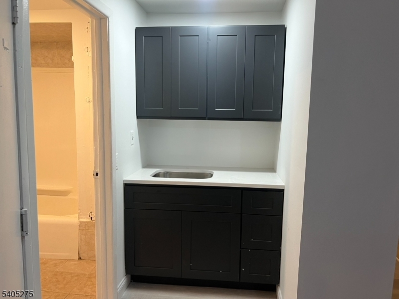 12 Quincy Street, Unit 1 Passaic, NJ 07055 - Photo 9 of 16 a bathroom with a sink and mirror