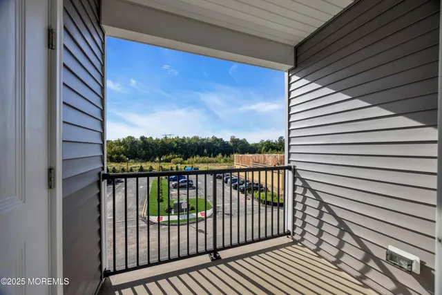 a view of a balcony with wooden floor