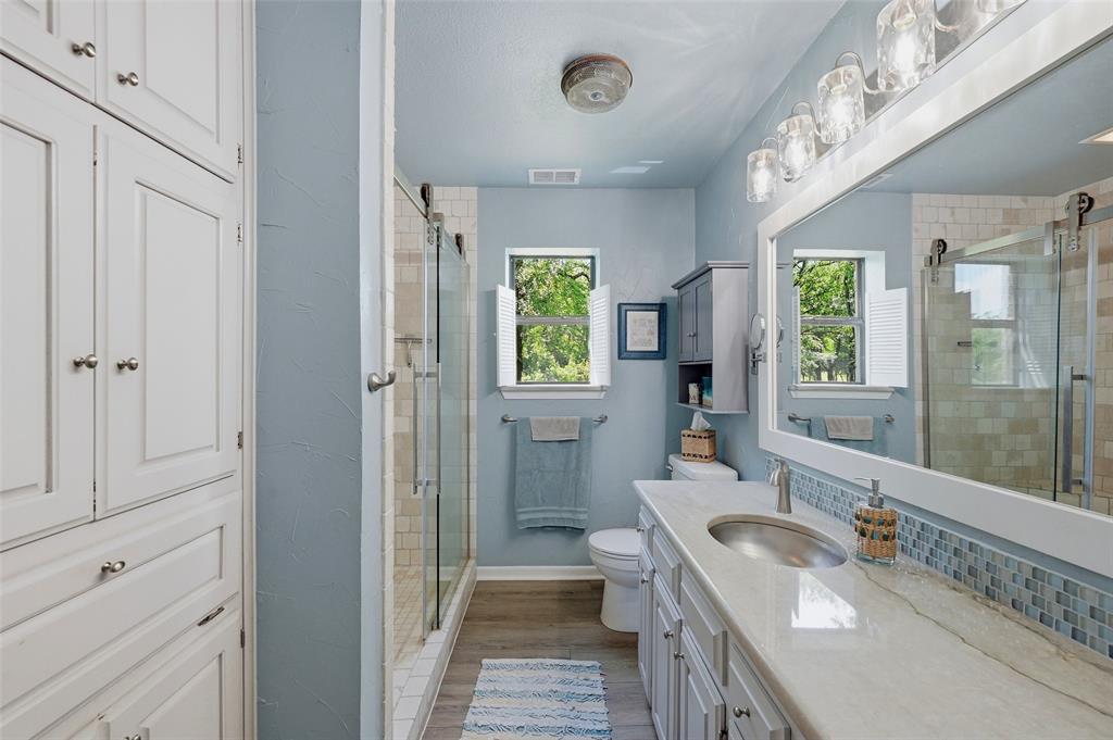 522 High Country Road Sherman, TX 75092 - Photo 17 of 38 a bathroom with a granite countertop tub a sink and a large mirror
