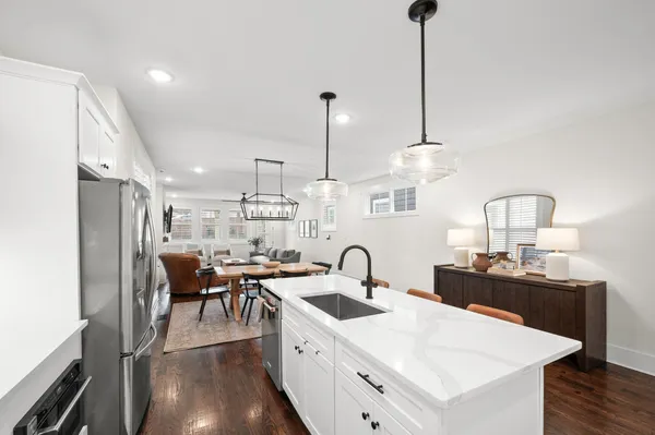 a kitchen with appliances a sink and cabinets