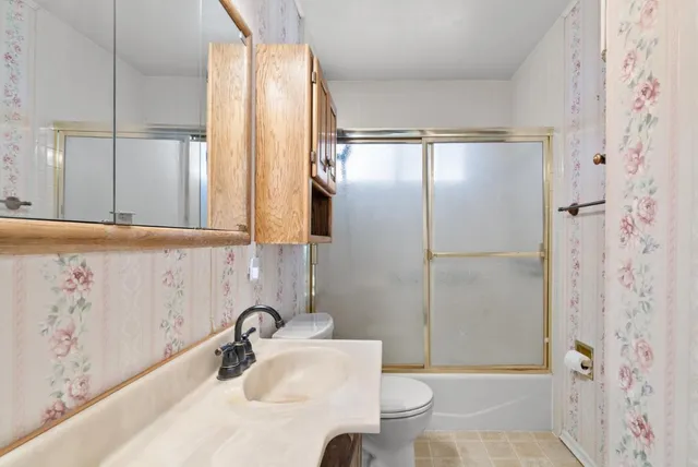 a bathroom with a sink toilet and shower