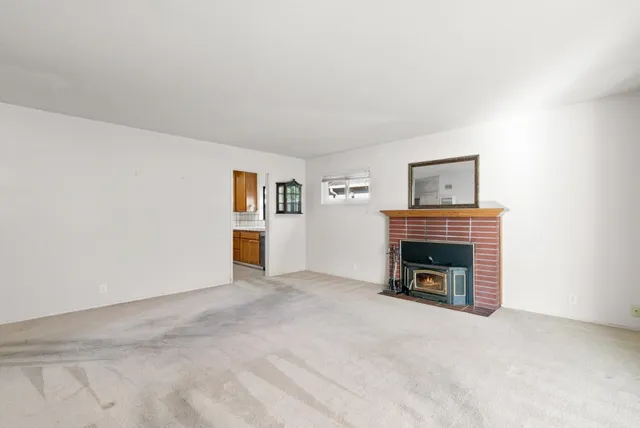a view of empty room with a fireplace