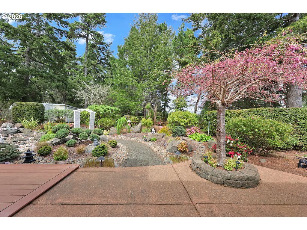 1415 20th Street Florence, OR 97439 - Photo 28 of 40 a view of a garden with a patio