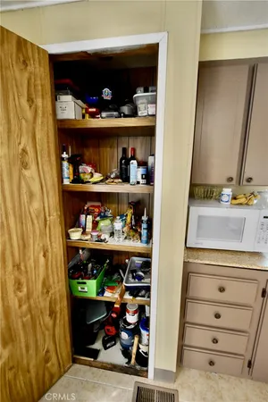 a bedroom with a bed and a wooden floor