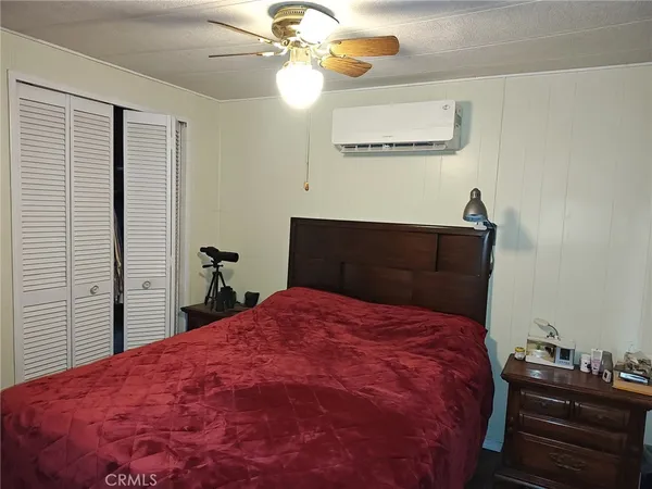 a bed sitting in a bedroom next to a window
