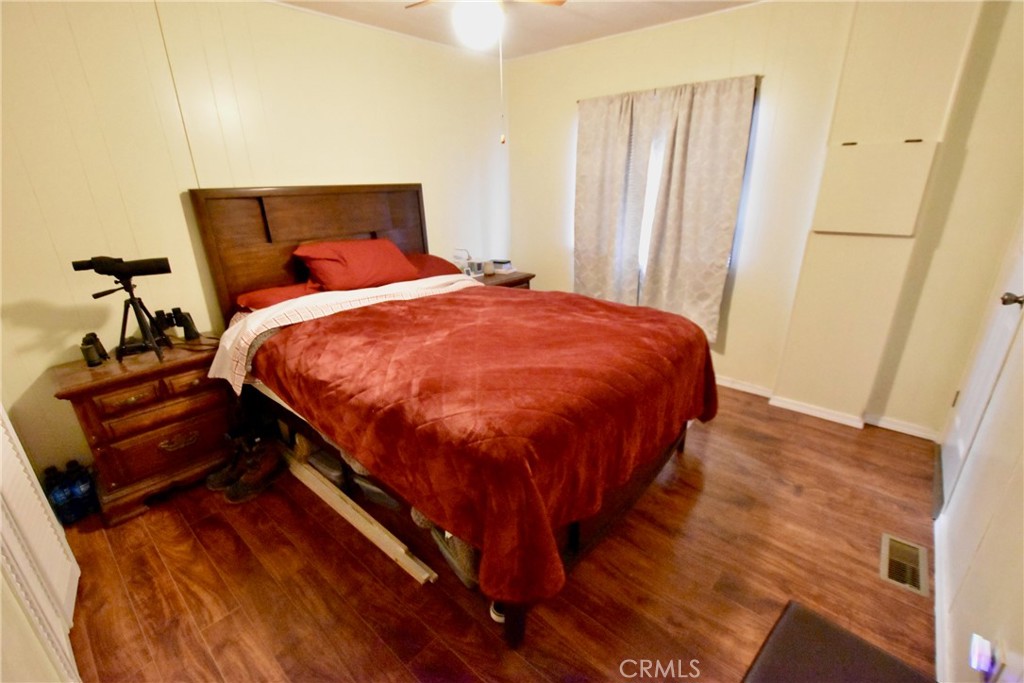 14804 Oregon Road Hornbrook, CA 96044 - Photo 16 of 26 a bed sitting in a bedroom next to a small yard