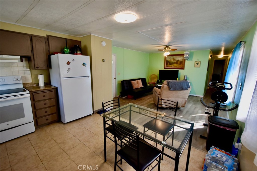14804 Oregon Road Hornbrook, CA 96044 - Photo 6 of 26 a living room with furniture a flat screen tv and a refrigerator