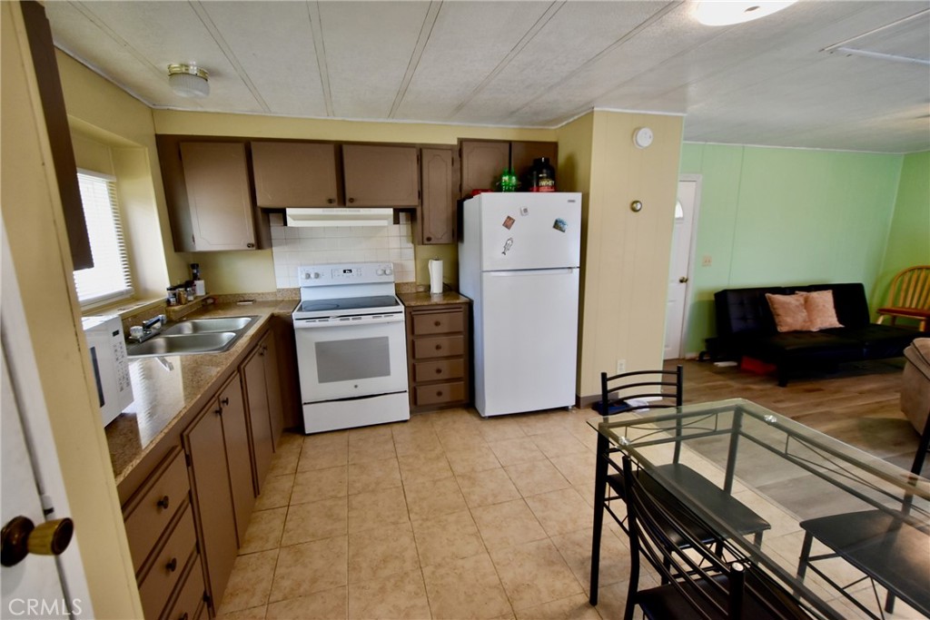 14804 Oregon Road Hornbrook, CA 96044 - Photo 9 of 26 a kitchen with a stove and a refrigerator