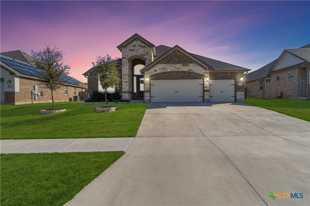 a front view of a house with a yard and garage