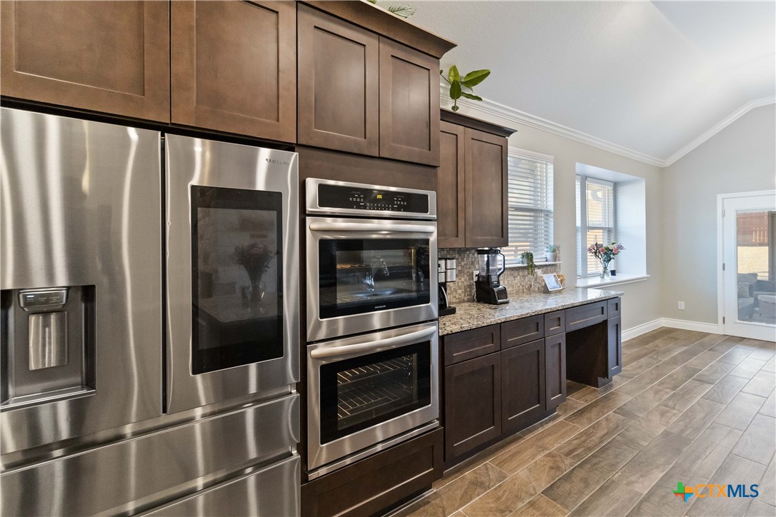 8402 Ridge Crest Drive Killeen, TX 76542 - Photo 14 of 34 a kitchen with stainless steel appliances and cabinets