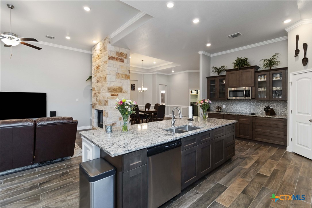 8402 Ridge Crest Drive Killeen, TX 76542 - Photo 16 of 34 a living room with stainless steel appliances kitchen island granite countertop a sink and cabinets