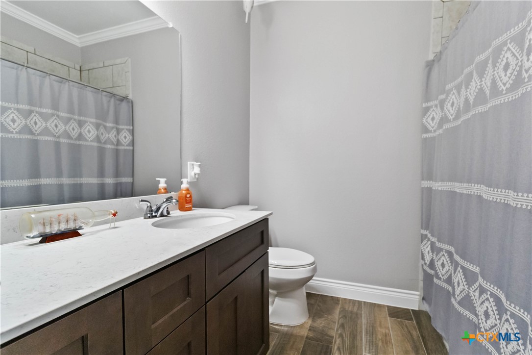 8402 Ridge Crest Drive Killeen, TX 76542 - Photo 19 of 34 a bathroom with a sink a toilet and shower