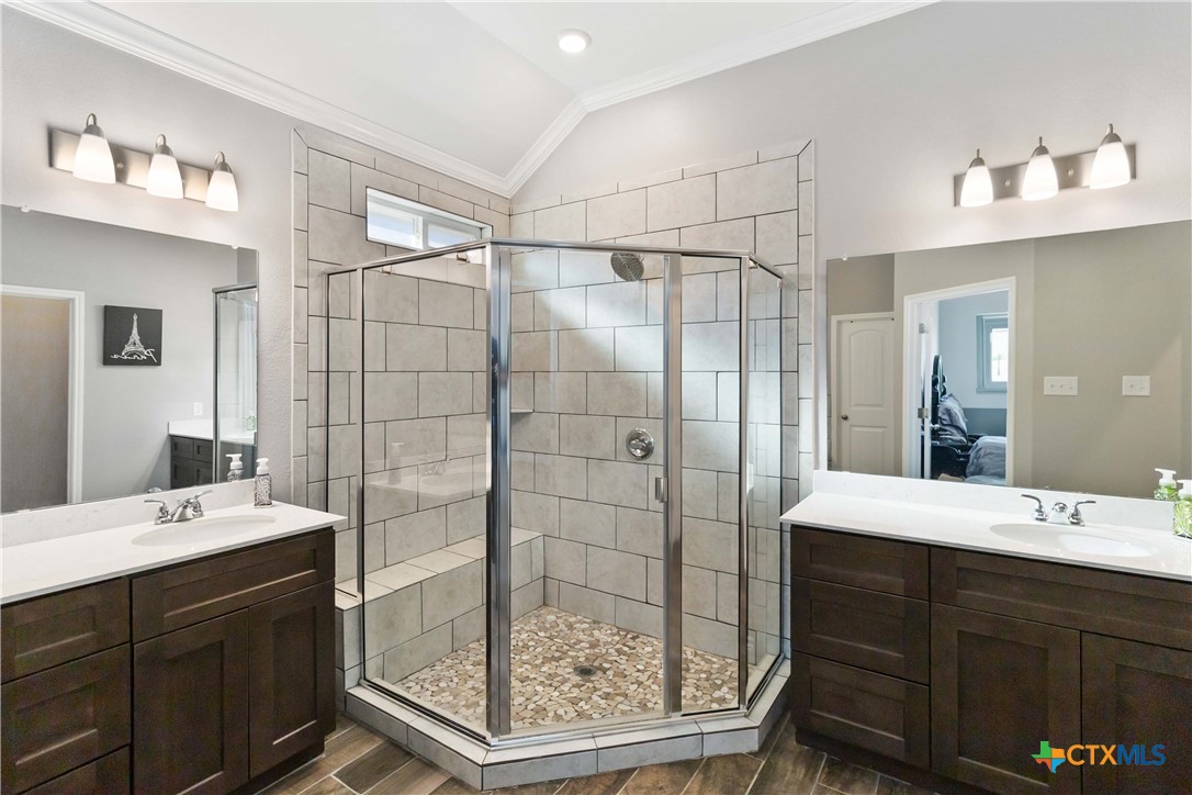 8402 Ridge Crest Drive Killeen, TX 76542 - Photo 23 of 34 a bathroom with a double vanity sink mirror and shower