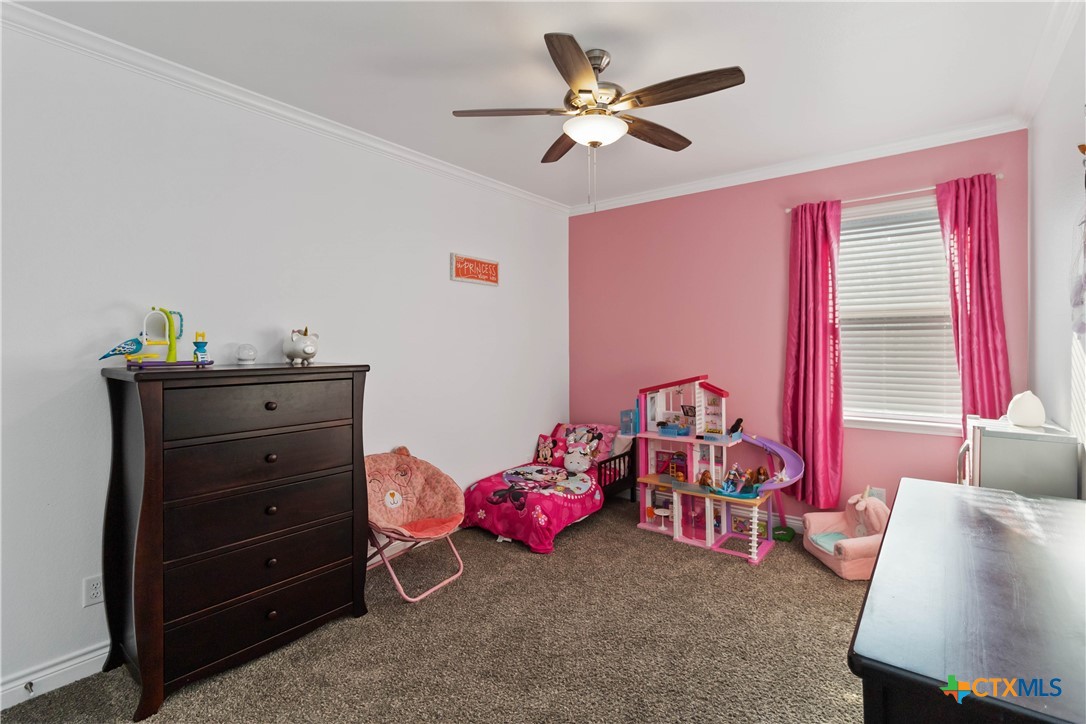 8402 Ridge Crest Drive Killeen, TX 76542 - Photo 29 of 34 a bedroom with a bed and a chandelier