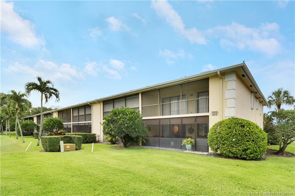 1001 Keystone Drive, Unit A Jupiter, FL 33458 - Photo 25 of 30 a view of a house with a yard and sitting area