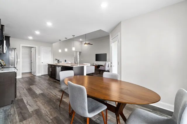 a dining room with furniture and wooden floor