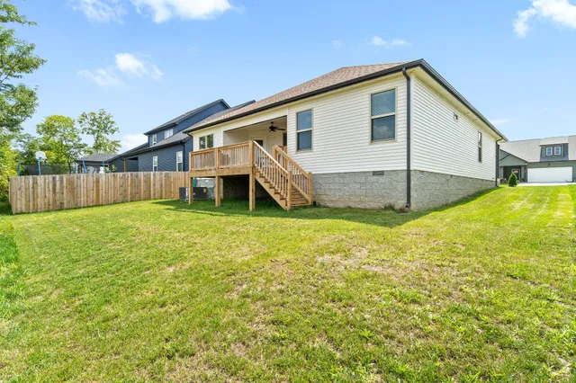 a view of a house with a yard and sitting area