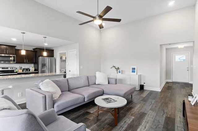 a living room with furniture and a wooden floor