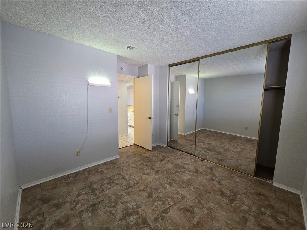 6750 Del Rey Avenue, Unit 133 Las Vegas, NV 89146 - Photo 25 of 34 Ample closet space with mirrored doors complements the durable flooring in this versatile room.