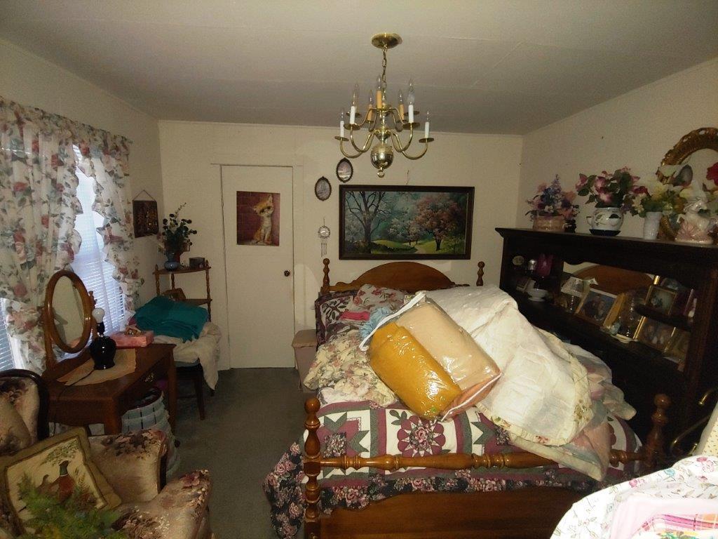 722 Poff School Road Riner, VA 24149 - Photo 22 of 49 a living room with fireplace furniture and a chandelier