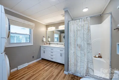 a bathroom with a double vanity sink toilet and shower
