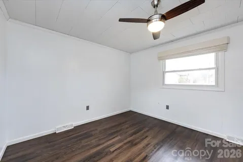 a view of a room with wooden floor and windows
