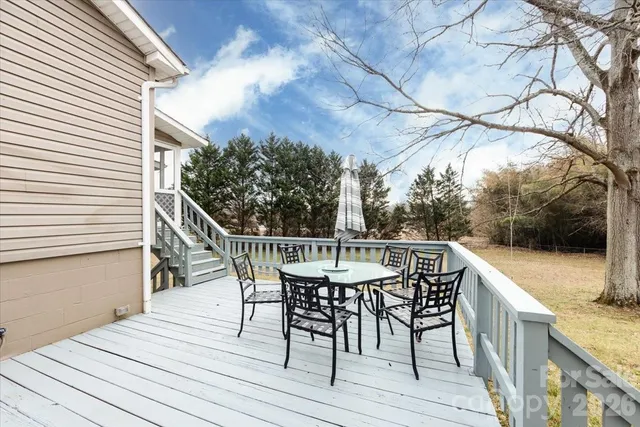 a patio with wooden floor and outdoor seating