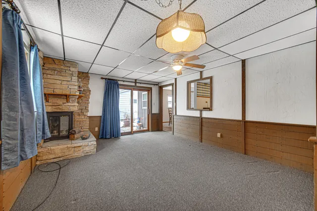 a view of a livingroom with a fireplace and window