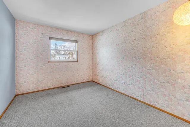 a view of an empty room and a window