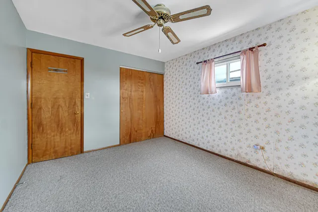 a view of a livingroom with a chandelier fan