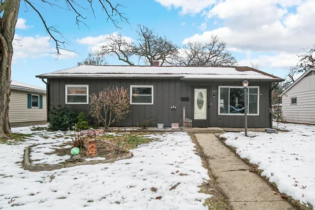 a view of a house with snow on the background